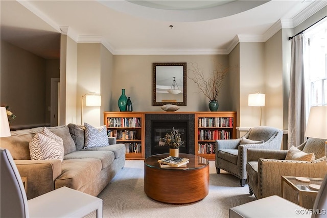 sitting room with ornamental molding, a glass covered fireplace, and carpet