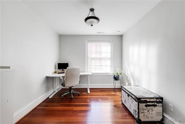 office space featuring visible vents, baseboards, and wood finished floors