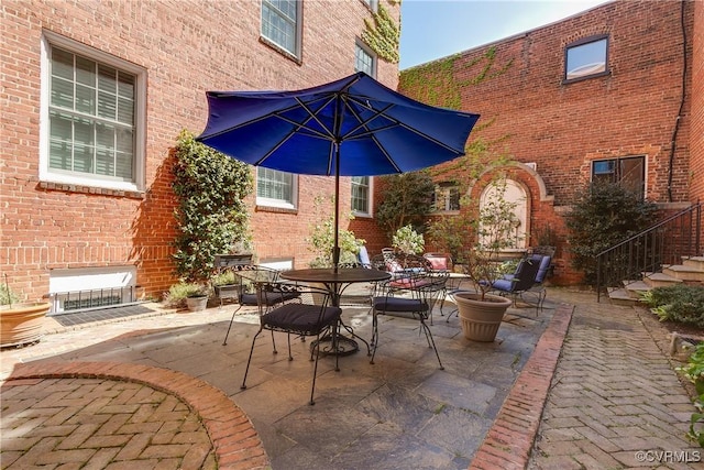 view of patio / terrace featuring stairs and outdoor dining space