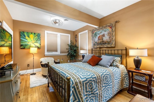 bedroom featuring wood-type flooring and baseboards