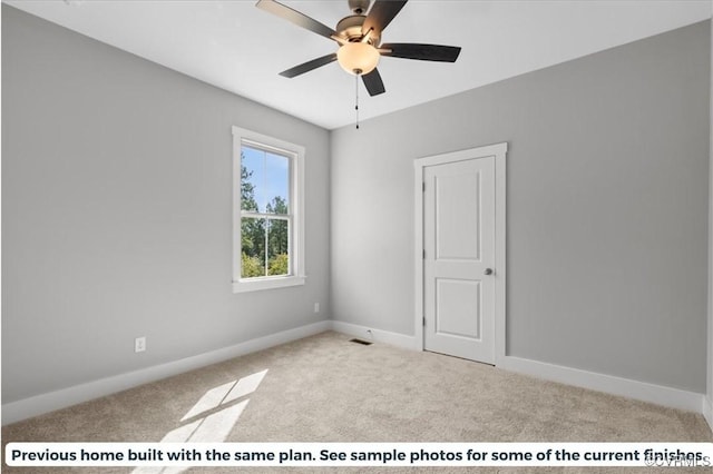 empty room with light colored carpet, ceiling fan, visible vents, and baseboards