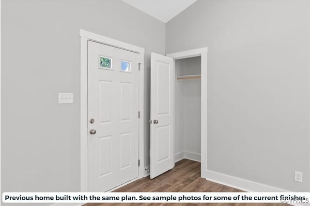 foyer entrance with baseboards and dark wood-style flooring