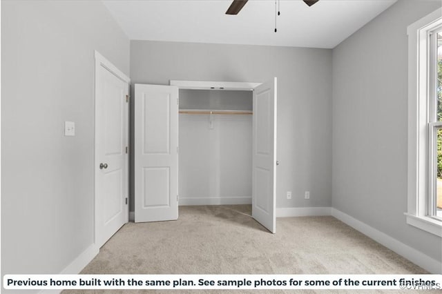 unfurnished bedroom featuring a closet, baseboards, a ceiling fan, and carpet flooring