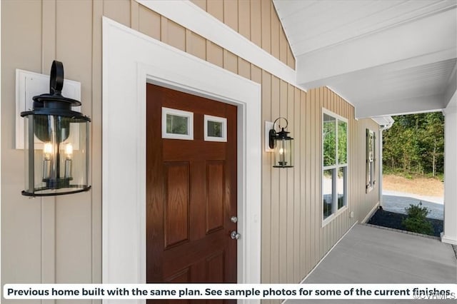 view of exterior entry featuring board and batten siding