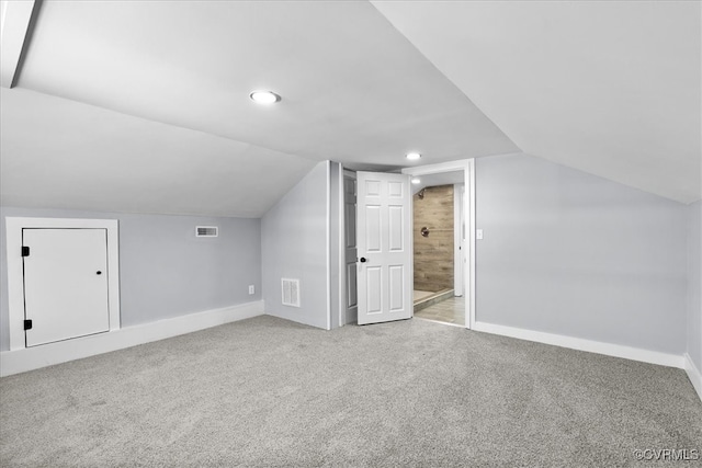 bonus room with carpet floors, visible vents, vaulted ceiling, and baseboards