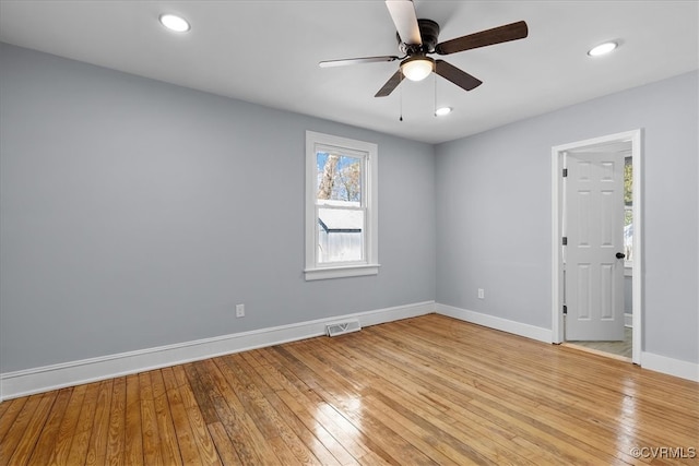 spare room featuring light wood-type flooring, visible vents, baseboards, and recessed lighting