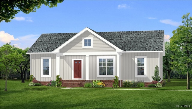 view of front facade with board and batten siding, a front yard, and roof with shingles