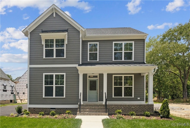 view of front of house featuring metal roof, a porch, and a standing seam roof