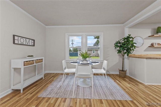 unfurnished dining area with light wood finished floors, baseboards, and ornamental molding