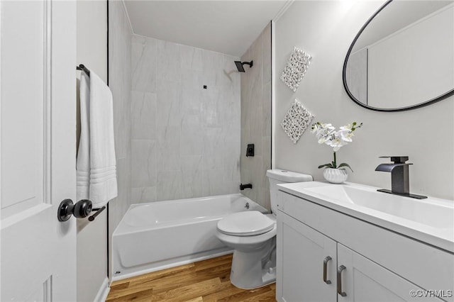 full bath with toilet, bathtub / shower combination, wood finished floors, and vanity