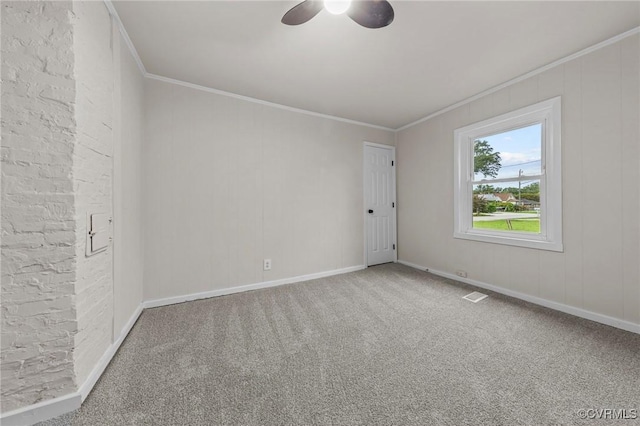 carpeted spare room with visible vents, ornamental molding, and baseboards