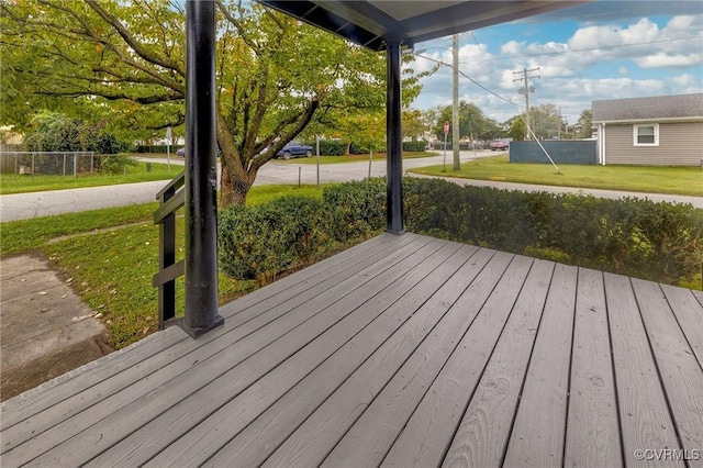 wooden terrace with fence and a lawn