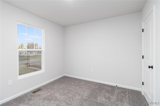 carpeted empty room with baseboards and visible vents