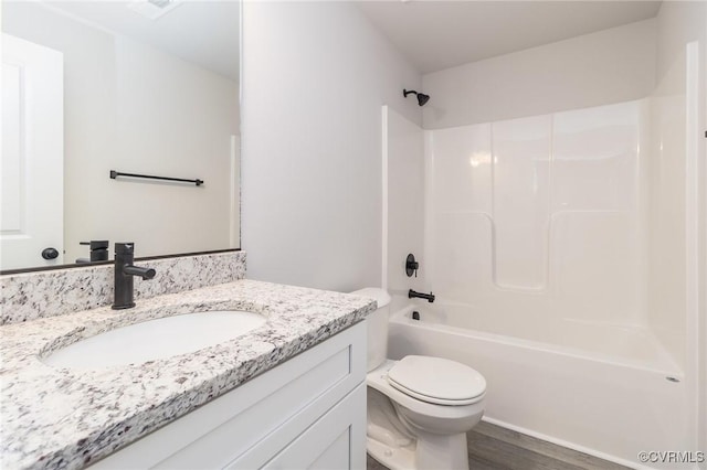 full bathroom with shower / tub combination, vanity, toilet, and wood finished floors