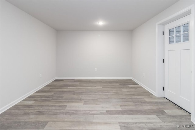 spare room featuring baseboards, recessed lighting, and light wood-style floors