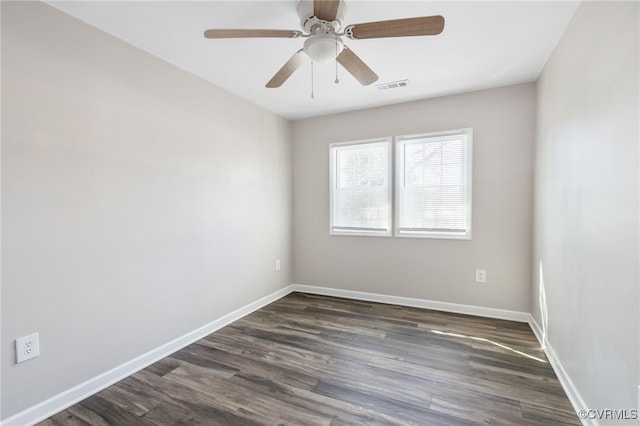 unfurnished room featuring dark wood-style floors, ceiling fan, visible vents, and baseboards