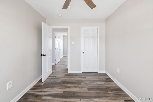 unfurnished bedroom featuring dark wood-style floors, ceiling fan, and baseboards