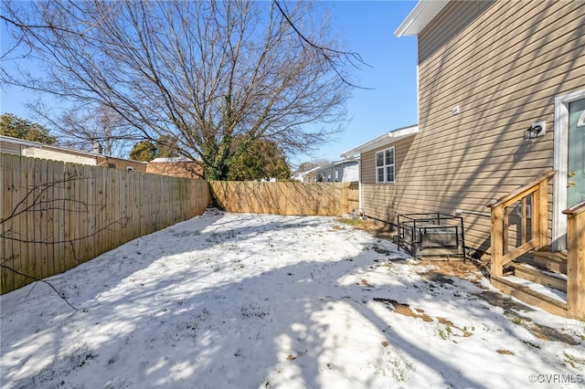 yard covered in snow featuring a fenced backyard