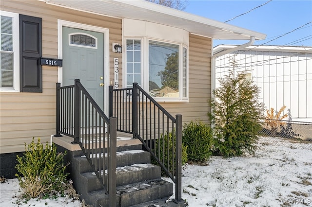 view of snow covered property entrance