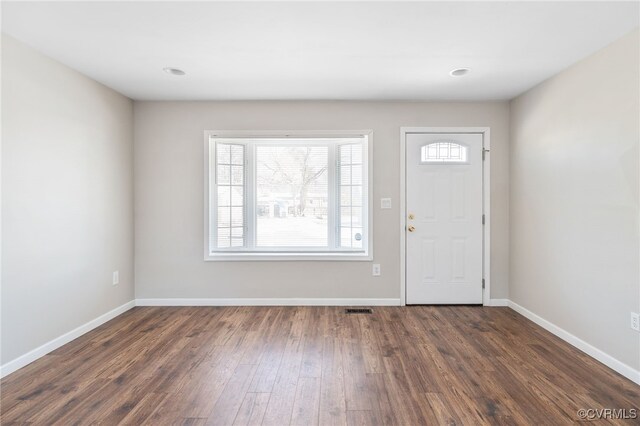 entryway featuring baseboards, visible vents, and dark wood-style flooring