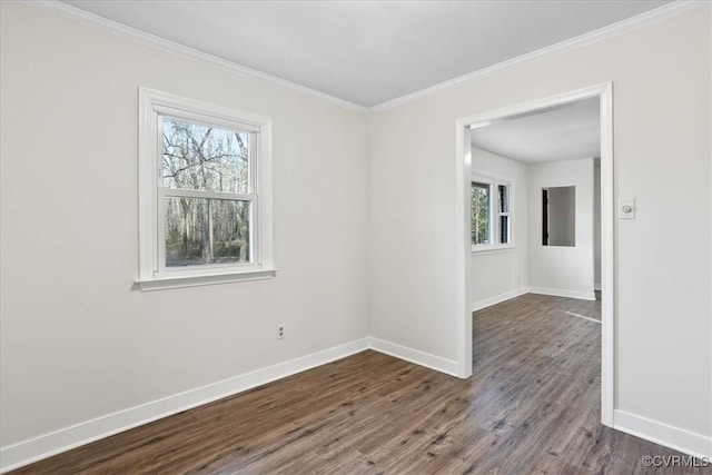 unfurnished room featuring ornamental molding, dark wood-style flooring, and baseboards