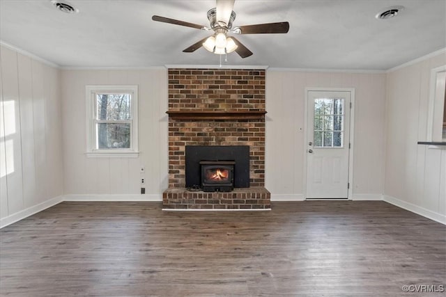 unfurnished living room featuring ornamental molding, dark wood-style flooring, visible vents, and a ceiling fan