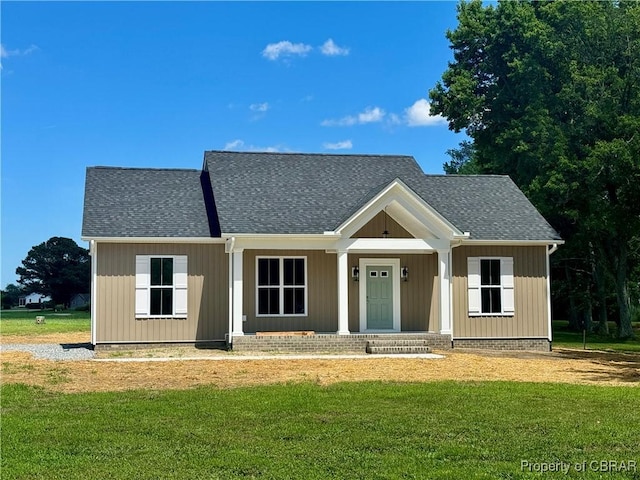 100 Bowsprit Ln, Wicomico Church, VA 22473 - view of front of house with covered porch, roof with shingles, and a front lawn