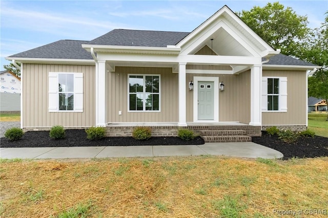100 Bowsprit Ln, Wicomico Church, VA 22473 - view of front of house with covered porch, a front yard, and roof with shingles