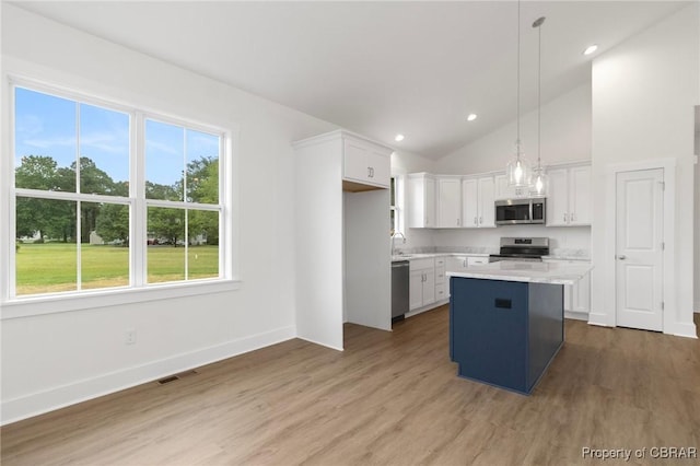 100 Bowsprit Ln, Wicomico Church, VA 22473 - kitchen with appliances with stainless steel finishes, white cabinets, light countertops, wood finished floors, and vaulted ceiling