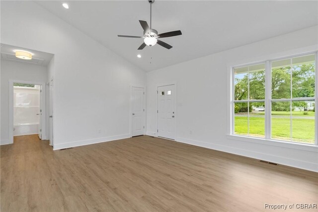 100 Bowsprit Ln, Wicomico Church, VA 22473 - empty room with light wood finished floors, a ceiling fan, recessed lighting, and high vaulted ceiling