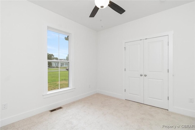 100 Bowsprit Ln, Wicomico Church, VA 22473 - unfurnished bedroom with light carpet, a closet, and ceiling fan