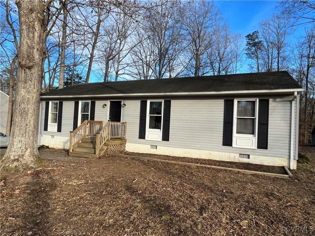 view of front facade with crawl space and roof with shingles