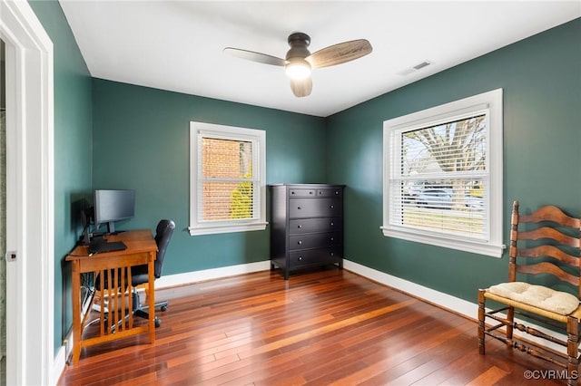 office area with a ceiling fan, baseboards, visible vents, and hardwood / wood-style floors