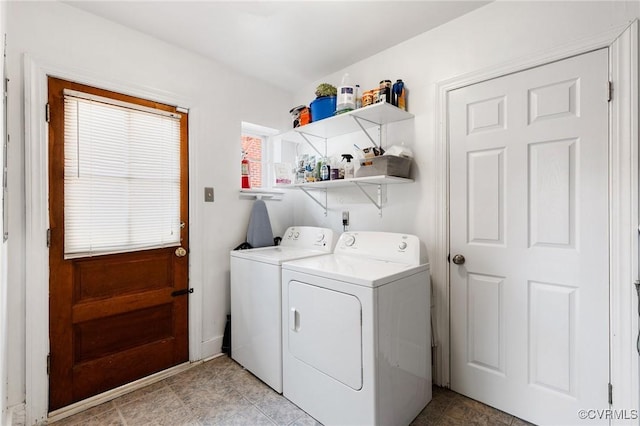 clothes washing area with laundry area and washer and clothes dryer