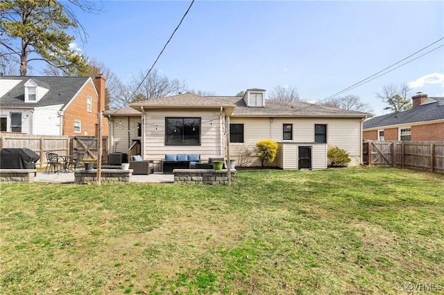 rear view of house with a fenced backyard, a patio, an outdoor living space, and a lawn