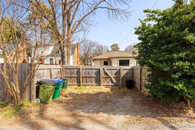 view of yard with fence and a gate