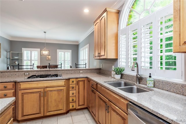 kitchen with light tile patterned floors, a sink, ornamental molding, appliances with stainless steel finishes, and pendant lighting