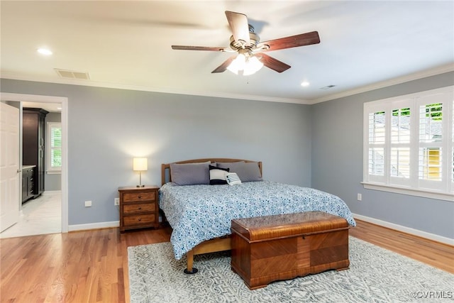 bedroom featuring visible vents, baseboards, and wood finished floors