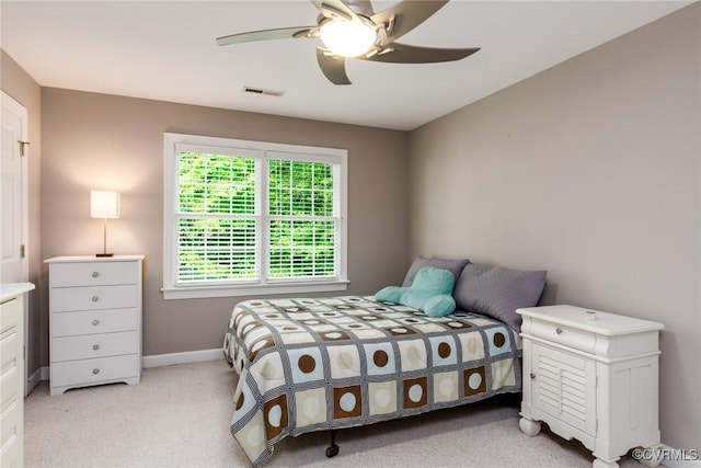 bedroom featuring visible vents, ceiling fan, light carpet, and baseboards