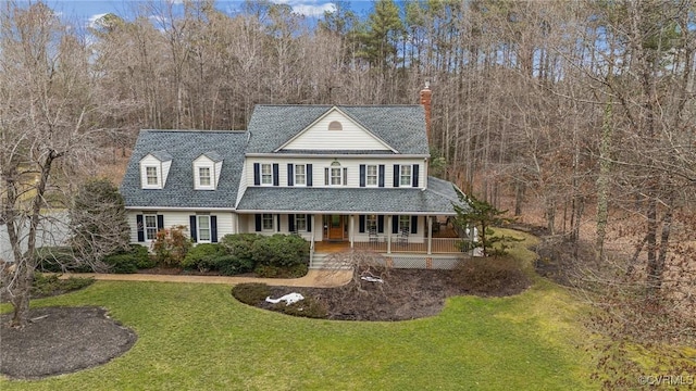 view of front of home with a porch and a front lawn