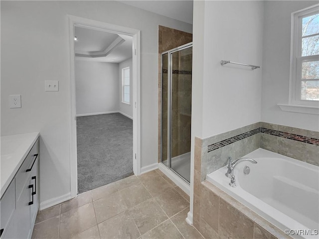 full bath with a stall shower, a garden tub, vanity, and tile patterned floors