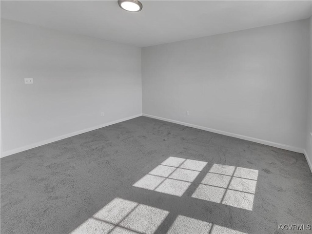 unfurnished room featuring carpet floors and baseboards