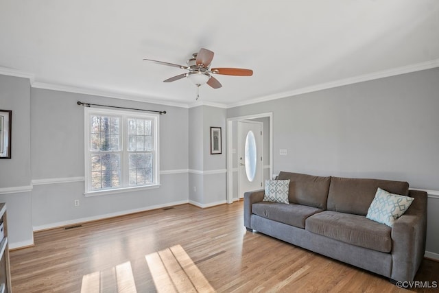 living area featuring ceiling fan, wood finished floors, visible vents, and baseboards