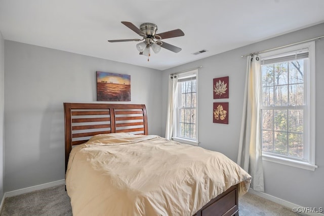 carpeted bedroom with visible vents, ceiling fan, and baseboards