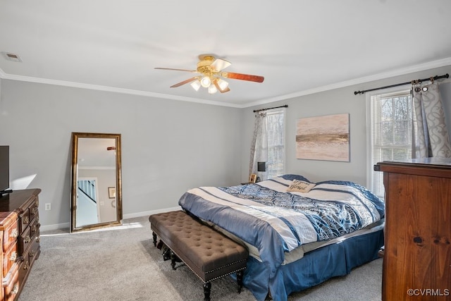 bedroom featuring carpet floors, visible vents, ornamental molding, ceiling fan, and baseboards