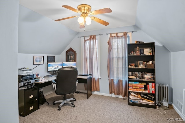 carpeted office featuring baseboards, vaulted ceiling, radiator heating unit, and ceiling fan