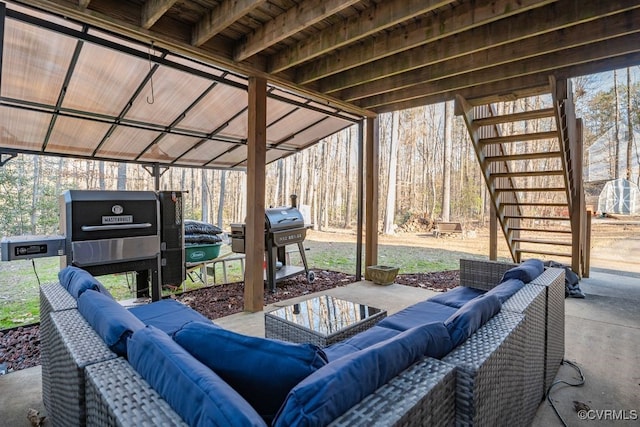 view of patio featuring grilling area, stairs, and outdoor lounge area