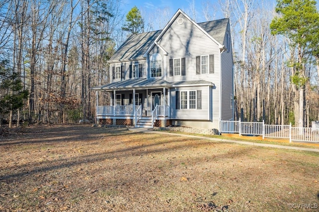 view of front of home with covered porch, a front yard, and fence