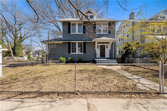 american foursquare style home featuring a fenced front yard