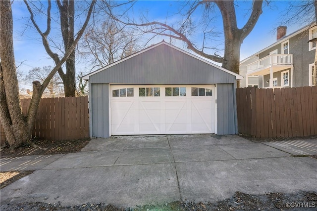 detached garage featuring fence